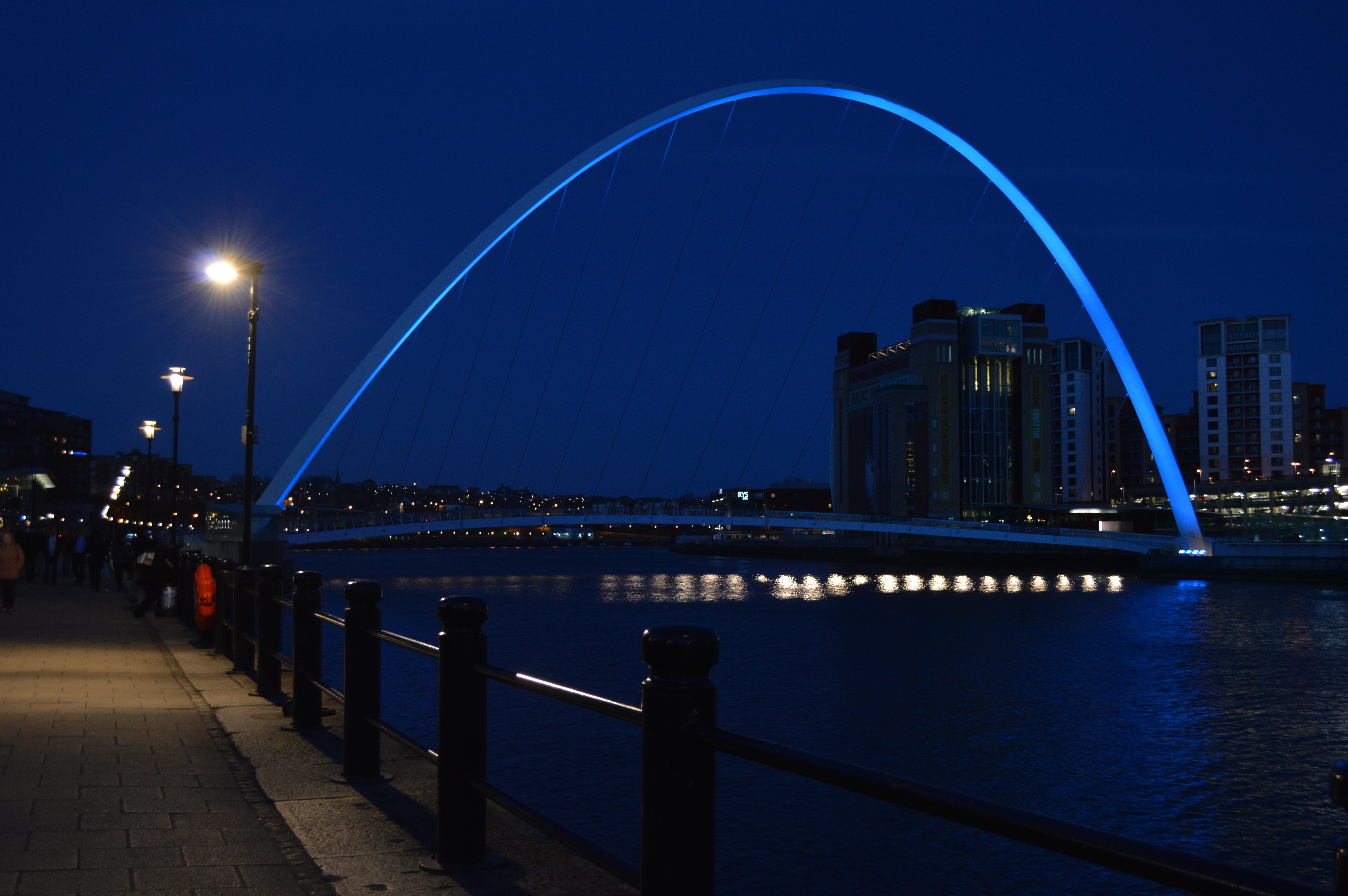 a bridge lit blue at dusk